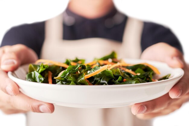 hands holding prepared dish